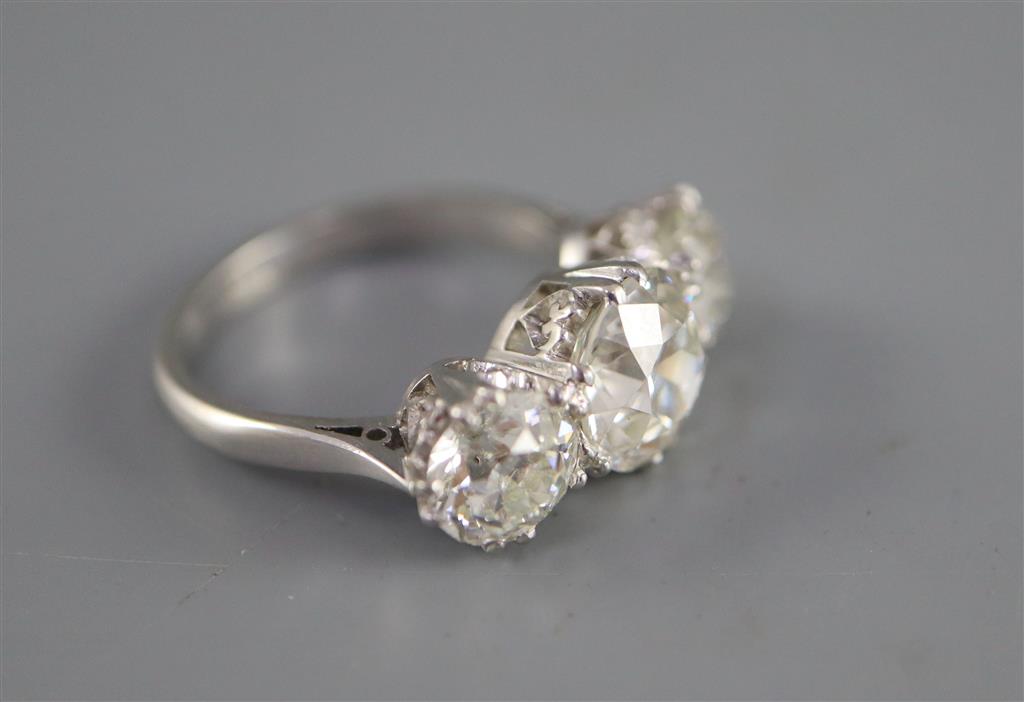 An impressive platinum and three stone diamond ring,